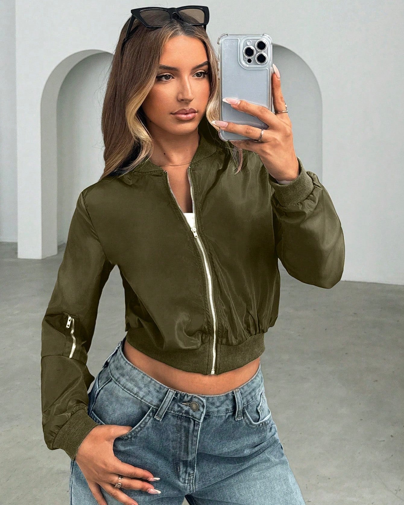 Olive green short bomber jacket with front zipper and side pockets