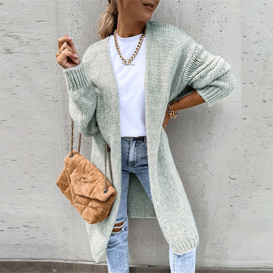 Long light green knit cardigan with open front, ribbed cuffs and textured knit hem.