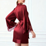 Red satin short robe with lace-trim sleeves, tied waist, and relaxed kimono cut