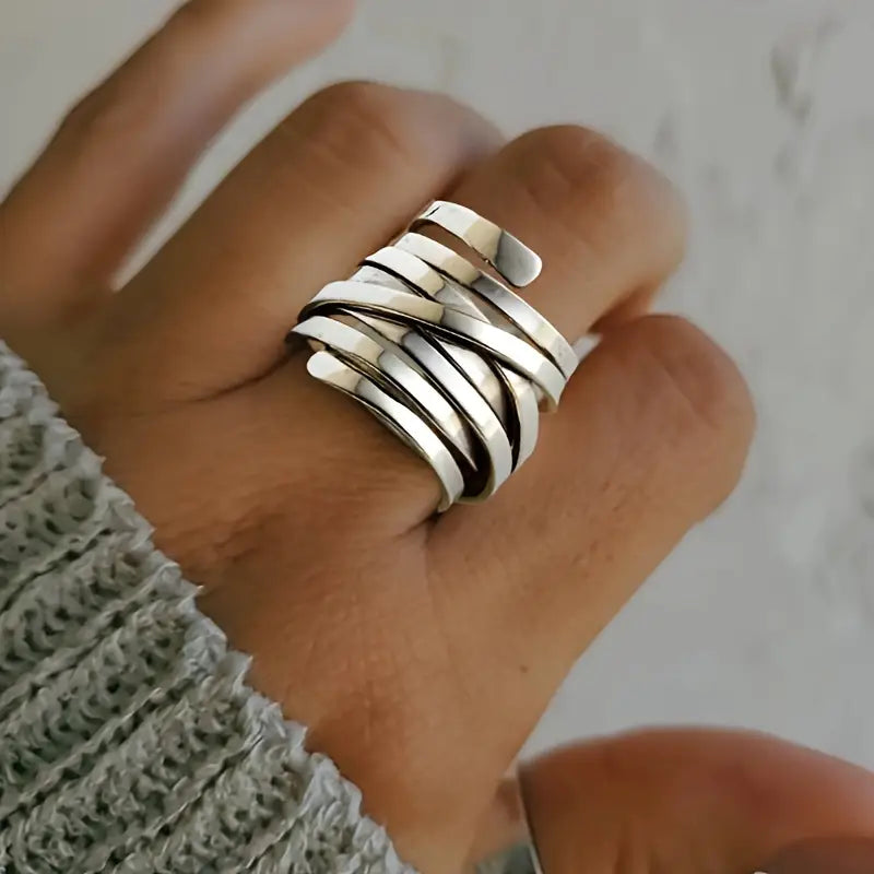 Silver stack ring with five wide polished bands and dark grooved stripes