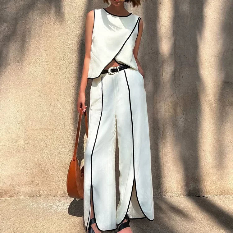 Women's white sleeveless top and wide-leg pants set with black trim, draped hem