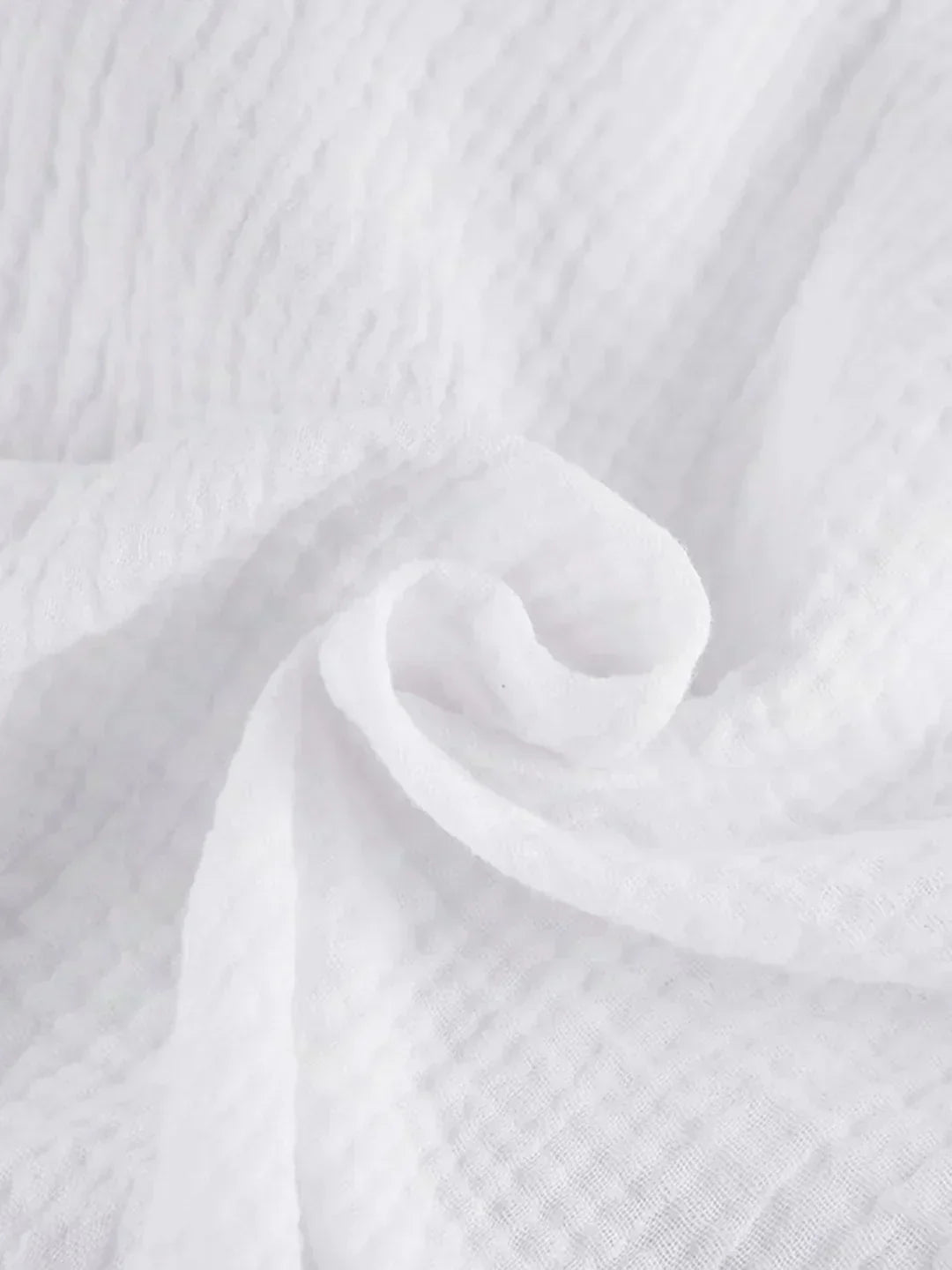 Close-up of white textured fabric with gathered seam detail