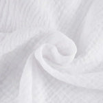 Close-up of white textured fabric with gathered seam detail