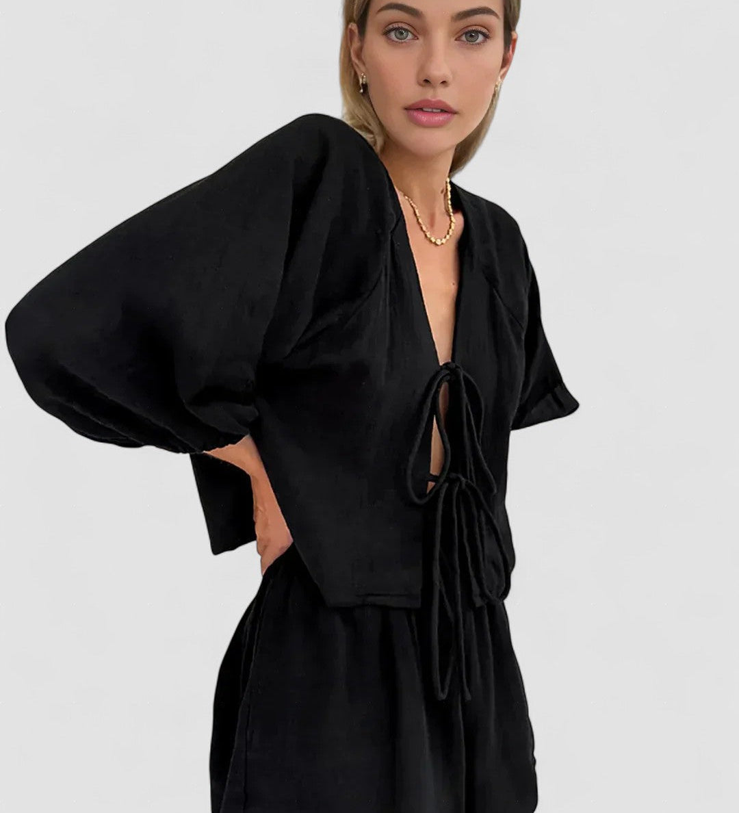 Black long-sleeve blouse and short set with bow-tie neckline and puff sleeves