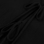 Close-up of black textured fabric with gathered folds and tie details