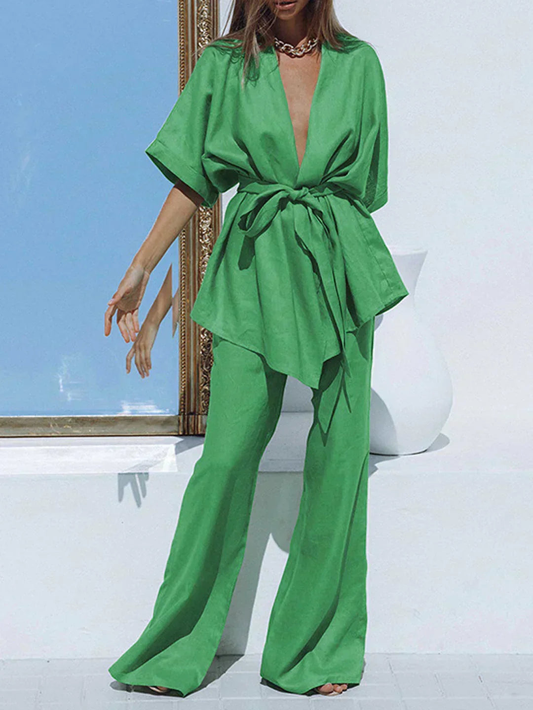 Green wide-leg trousers with tied waist and matching V-neck tunic, oversized fit