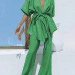 Green wide-leg trousers with tied waist and matching V-neck tunic, oversized fit