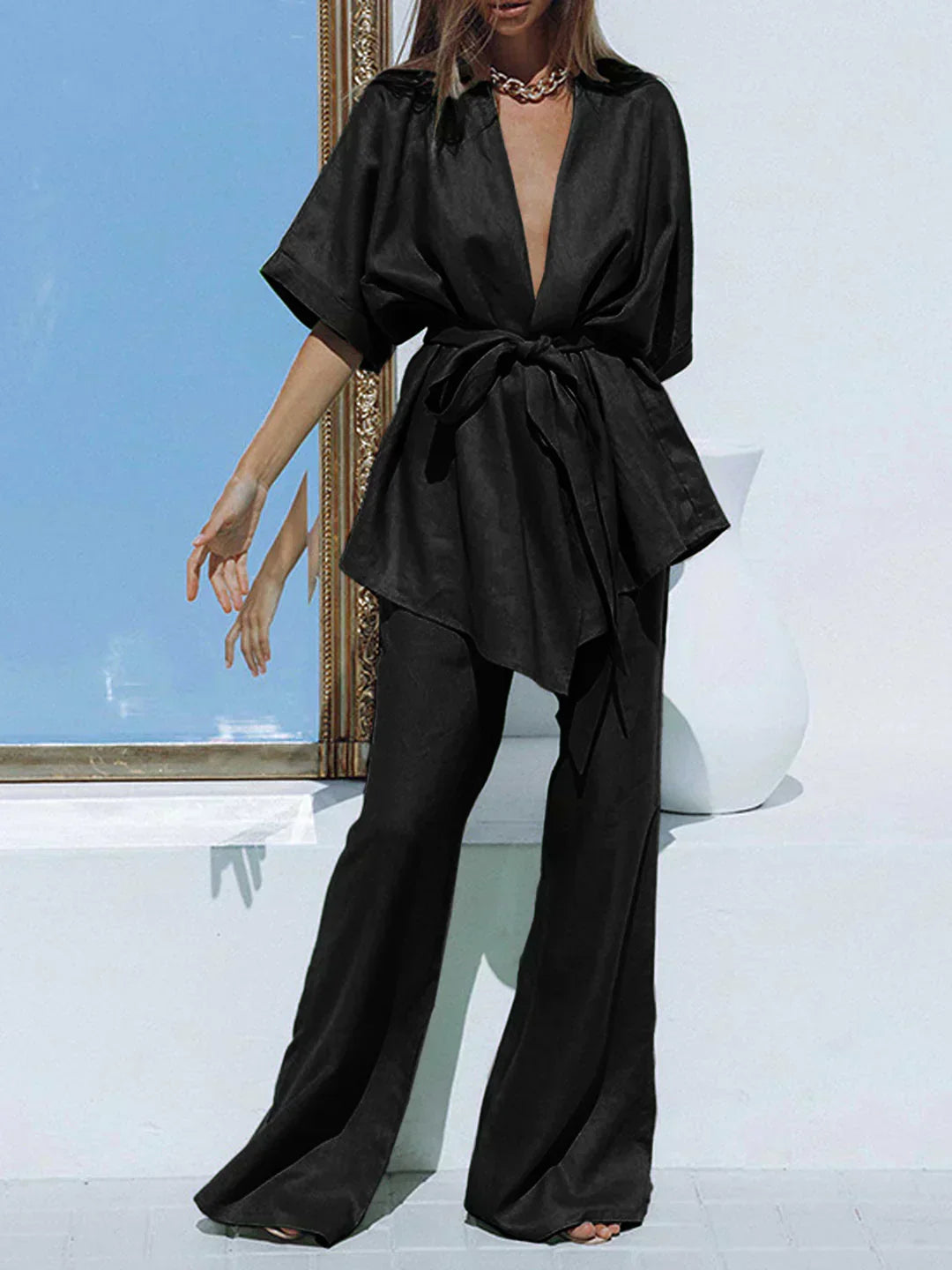 Black wide-leg trousers with tied waist and matching V-neck tunic, oversized look