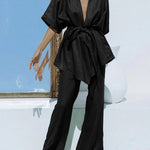 Black wide-leg trousers with tied waist and matching V-neck tunic, oversized look