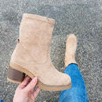 Beige suede ankle boot with stitched V seam and stacked heel, side view