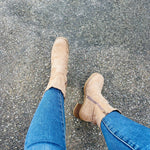 Beige suede ankle boots with low stacked heel, worn with blue jeans