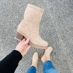 Beige suede ankle boot with stitched seam, stacked heel, and pull-on opening