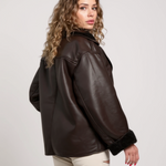 Women’s brown faux leather jacket with shearling cuffs and side view zip-front design