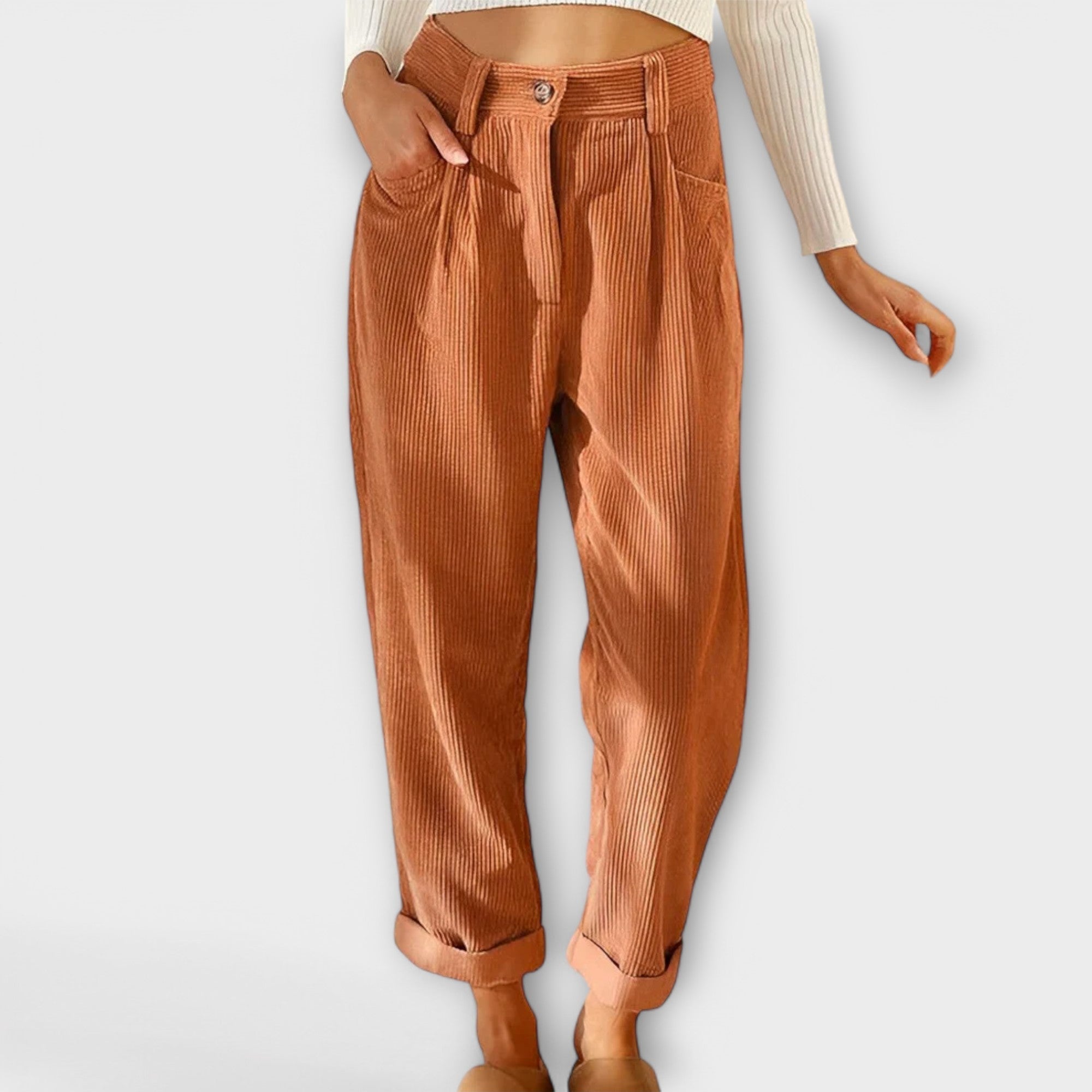 Cropped pants in rust orange with pleats, button fly, and side pockets