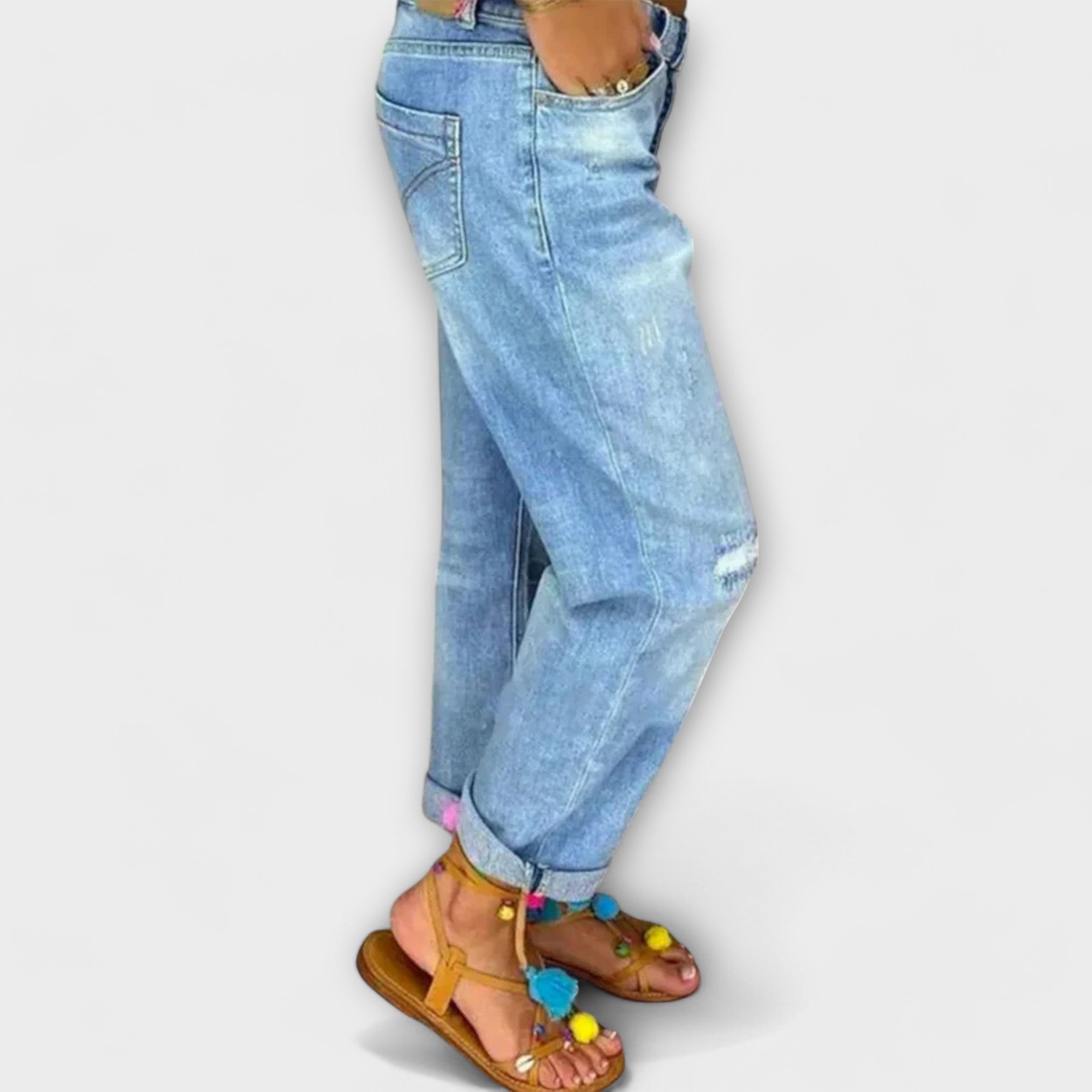 Light blue denim jeans, side view, distressed patches and side pockets