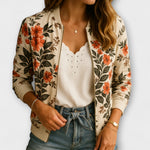 Cream floral zip-up jacket worn over white eyelet top