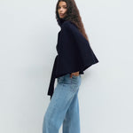 Dark navy short cape jacket with button front and tied waist belt