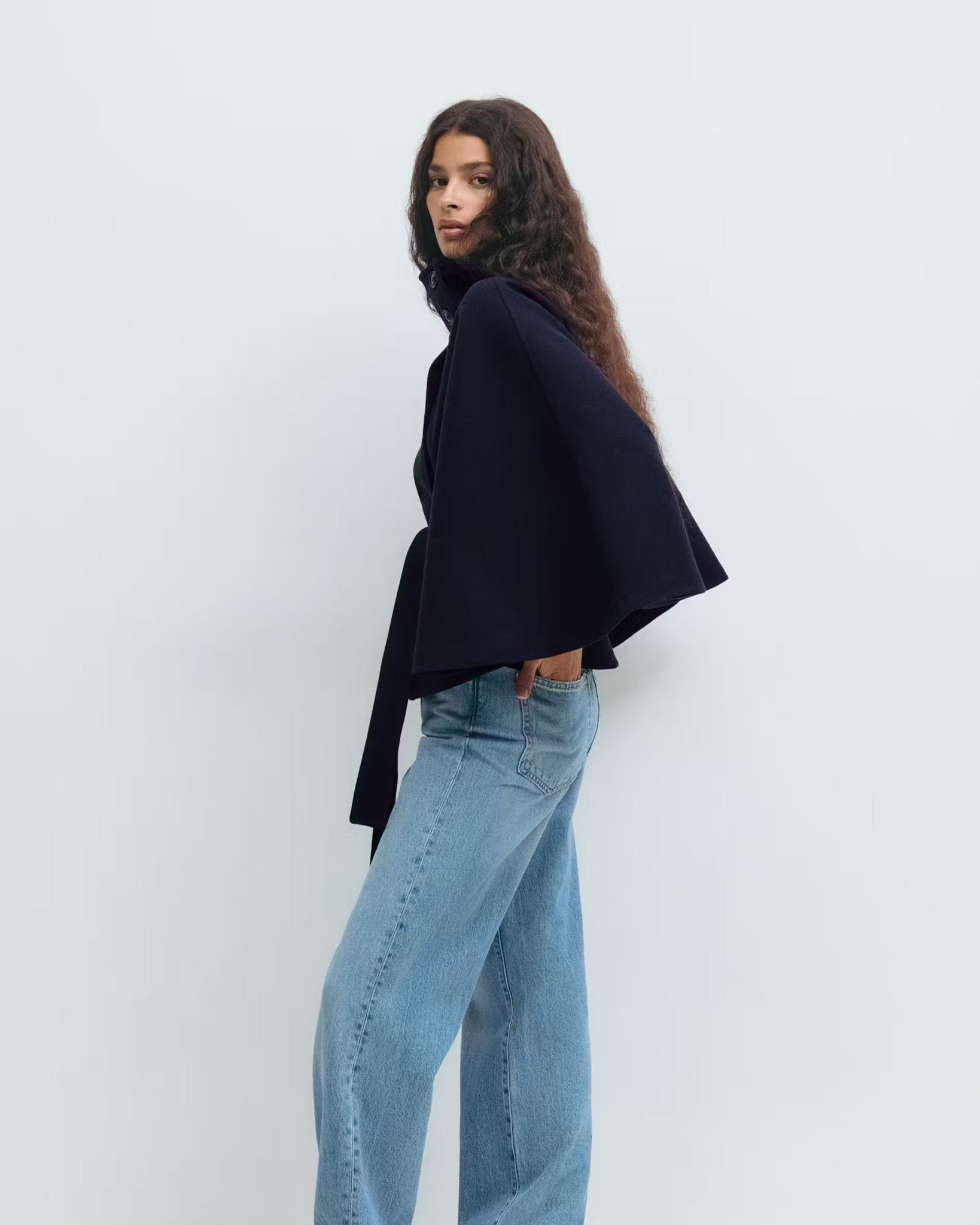 Dark navy short cape jacket with button front and tied waist belt
