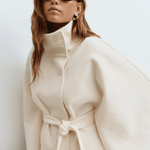 Cream belted jacket with high neck, button front, cape sleeves