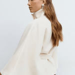 White belted jacket with high collar, button front, cape sleeves