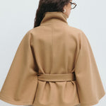 Camel back view of belted jacket with high neck and button placket