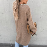 Long taupe knit cardigan with open front and side pockets, back view
