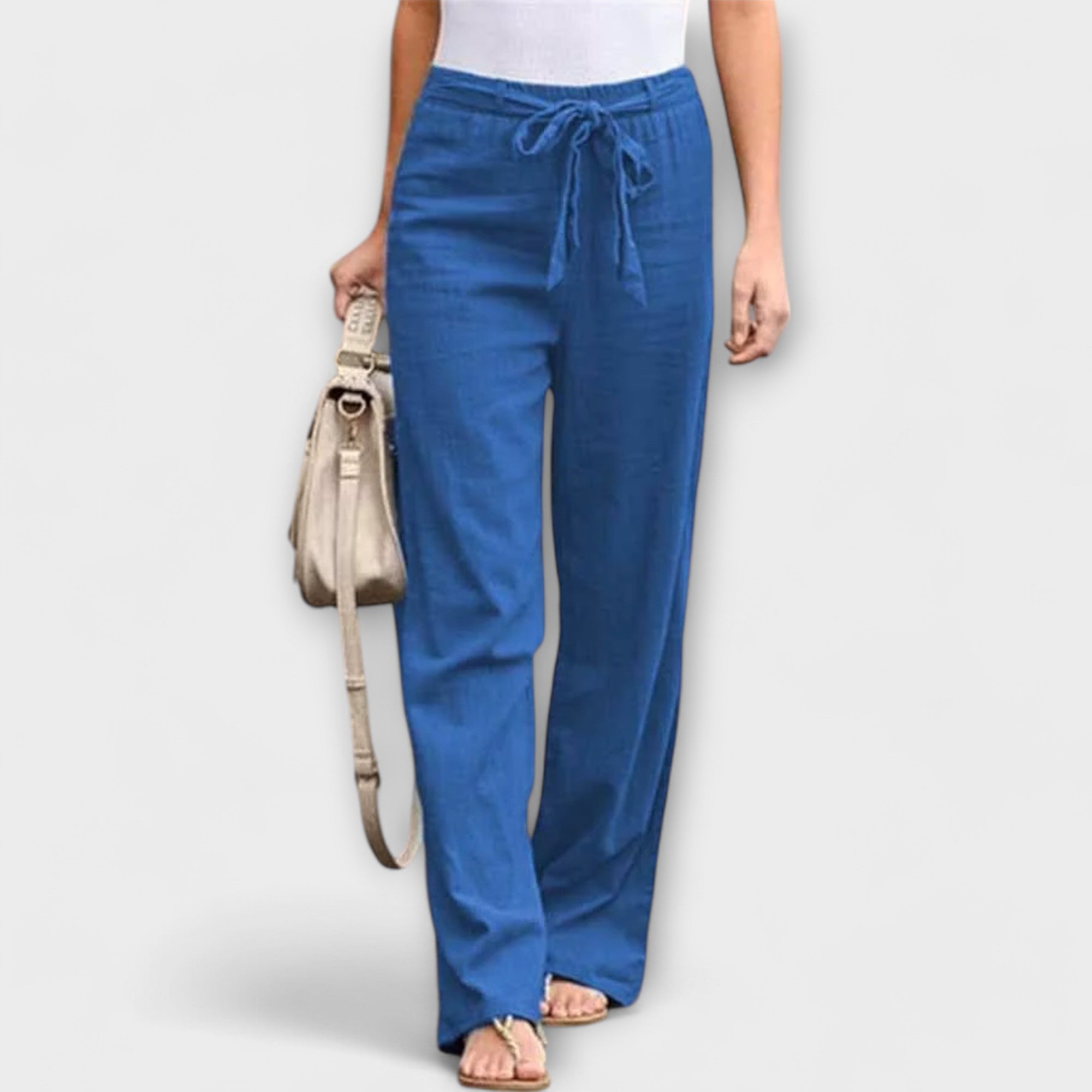 Blue linen pants with a drawstring waist and relaxed straight-leg fit