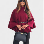 Burgundy cape-style coat with high neck, button closure, and waist belt