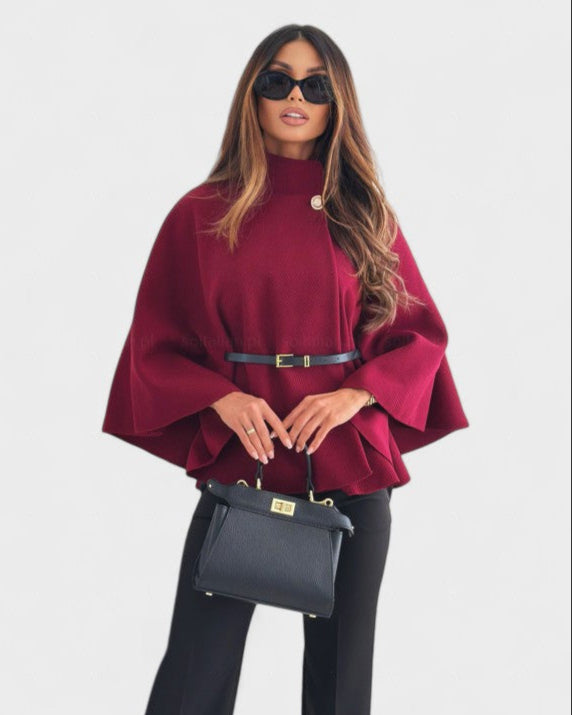 Burgundy cape-style coat with high neck, button closure, and waist belt