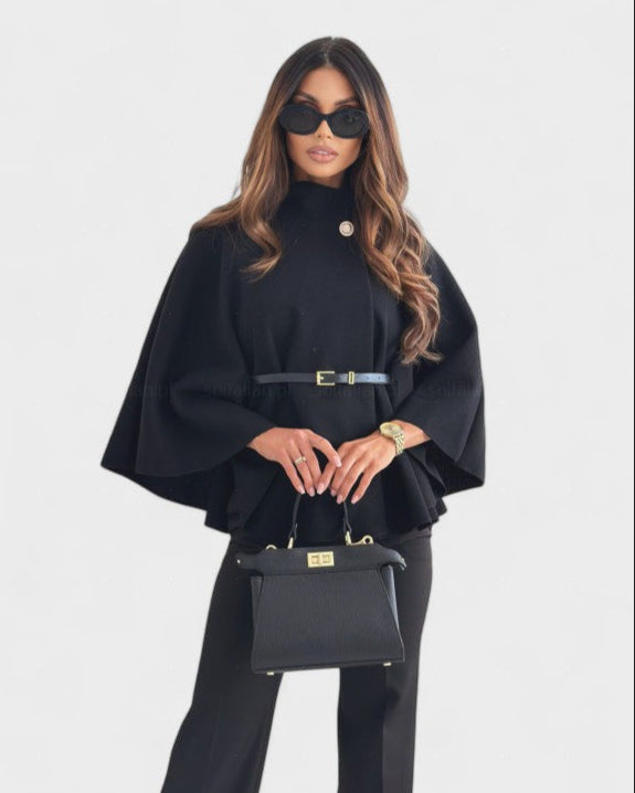Black cape-style coat with high neck, round buttons, and gold-buckle waist belt