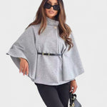 Light gray cape-style coat with high neck, button closure, and waist belt