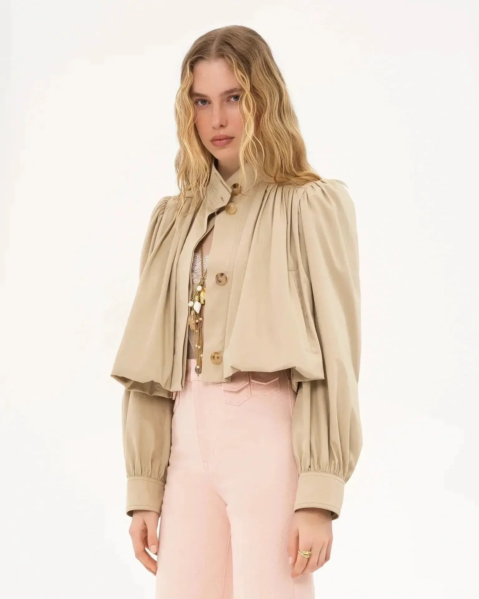 Cream cropped blouse jacket with gold buttons, high neck, and puffed sleeves