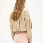 Cream cropped jacket with pleated back yoke and wide voluminous sleeves, button front