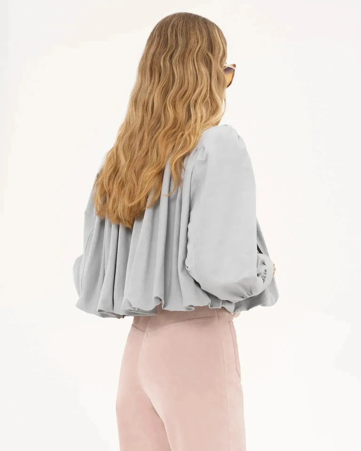 Light gray cropped jacket back view with pleated yoke and balloon-style sleeves