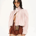 Pink short loose jacket with button front, pleated yoke, and voluminous balloon sleeves