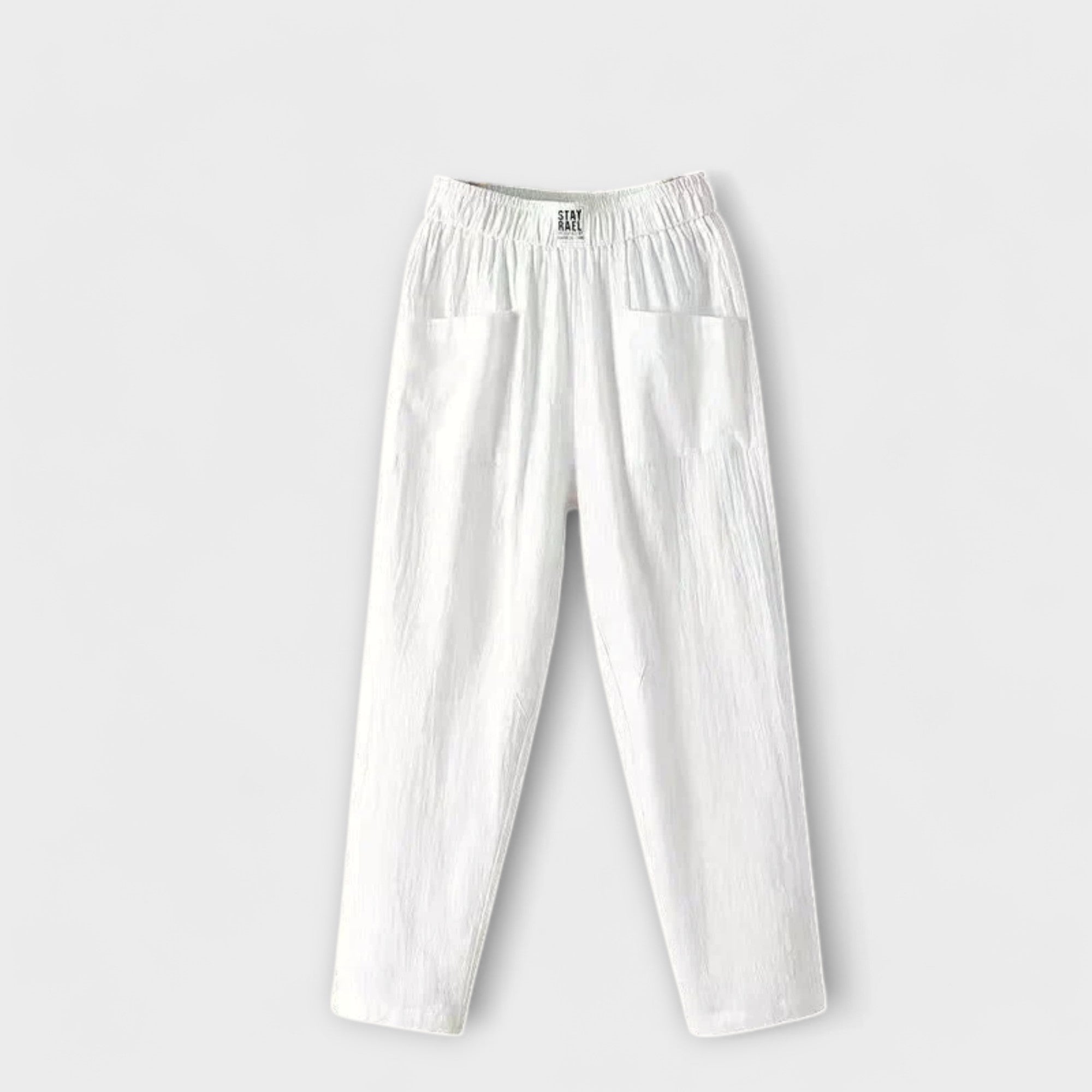 Linen trousers in white with elastic waistband and side patch pockets