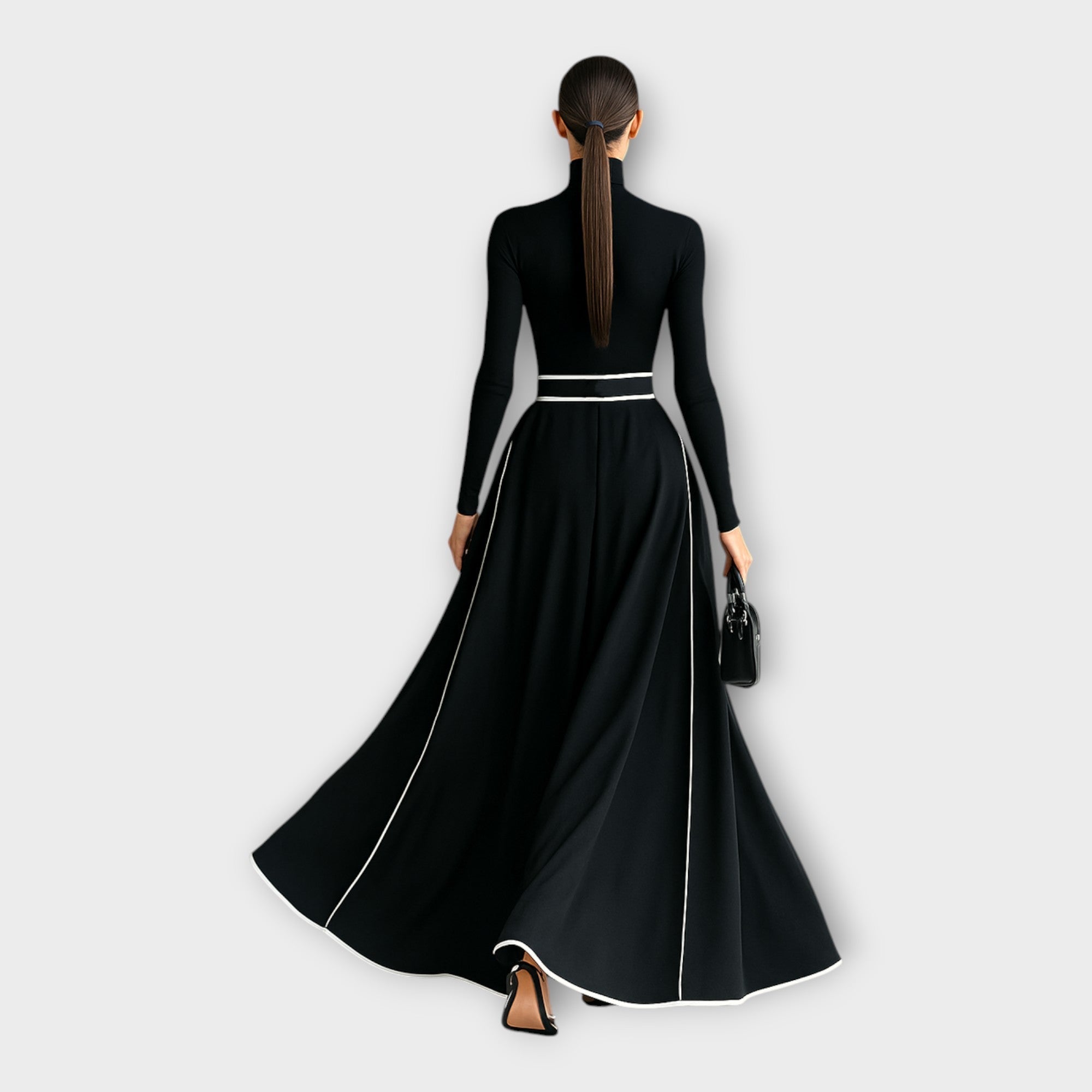 Black long-sleeve maxi dress with high back, silver-buckle belt, flowing skirt with piping
