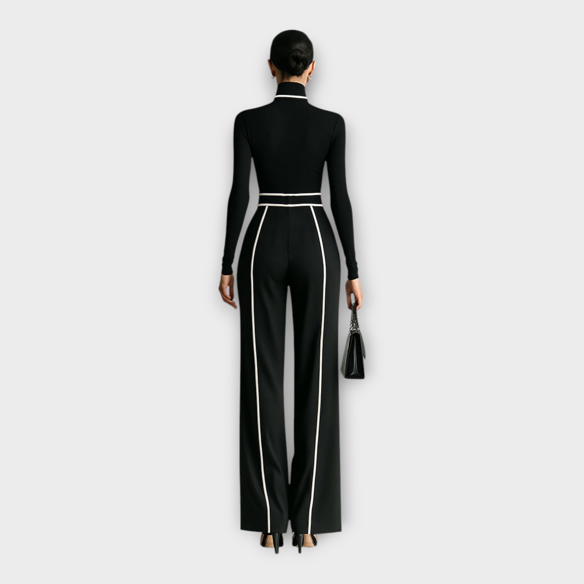 Women's black turtleneck jumpsuit with contrast piping, belt, back view