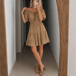 Off-shoulder tiered mini dress in taupe beige with puff sleeves and smocked waist