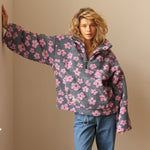 Dark fuzzy fleece half-zip hoodie with pink flower pattern and hooded neckline