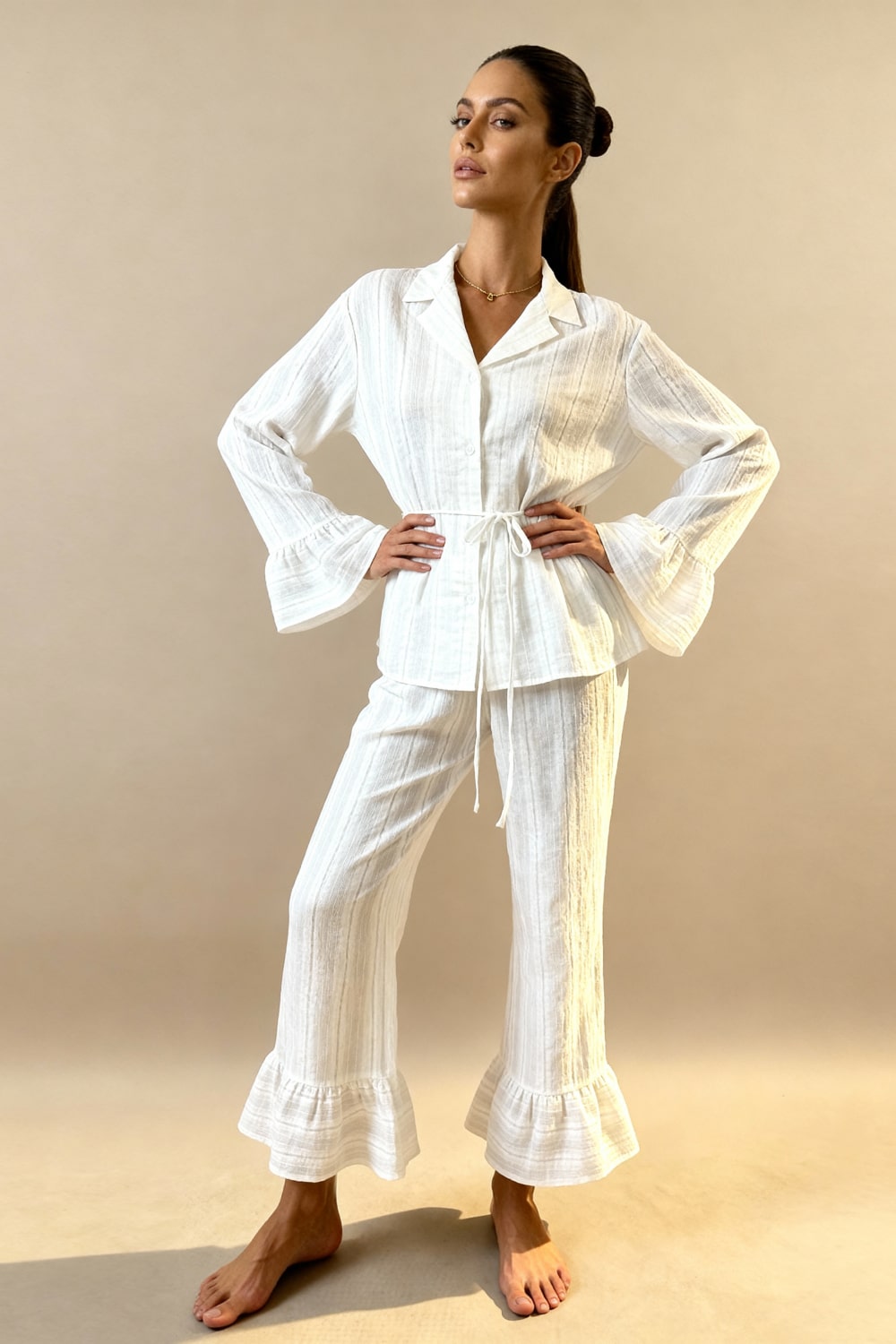 White pajama set with button-up top, tie waist, and wide-leg pants