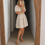 Cream off-shoulder tiered dress with puff sleeves and gathered smocked waist