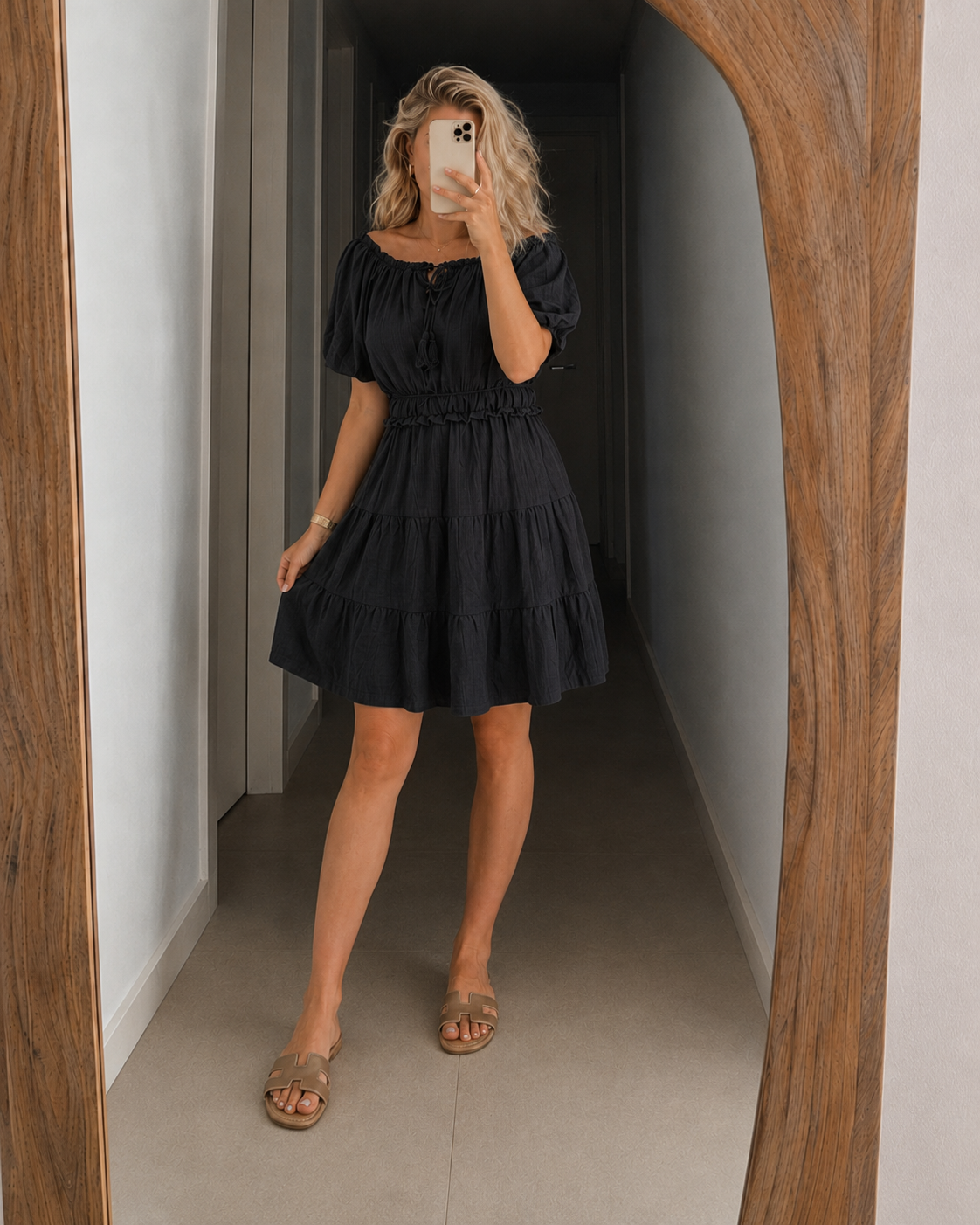 Black off-shoulder tiered mini dress with puff sleeves and smocked waist
