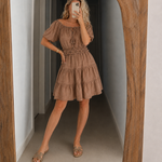Tan off-shoulder tiered dress with short puff sleeves and elastic smocked waist