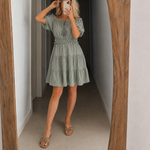 Light blue off-shoulder tiered dress with puff sleeves and smocked waist