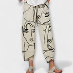 Nahia linen pants with black face line print, drawstring waist and cropped wide legs