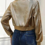 Gold metallic short zip jacket with stand collar and ribbed cuffs, back view