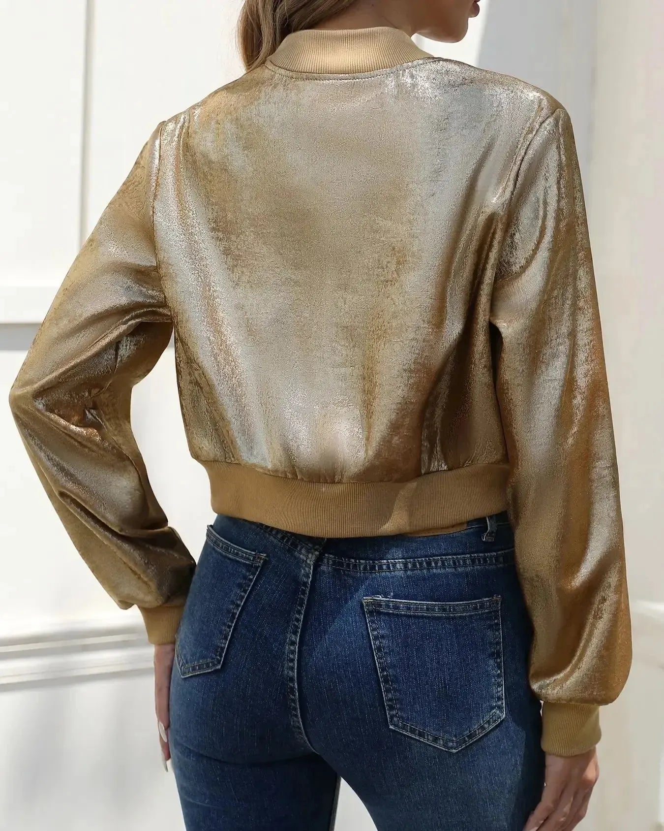 Gold metallic short zip jacket with stand collar and ribbed cuffs, back view