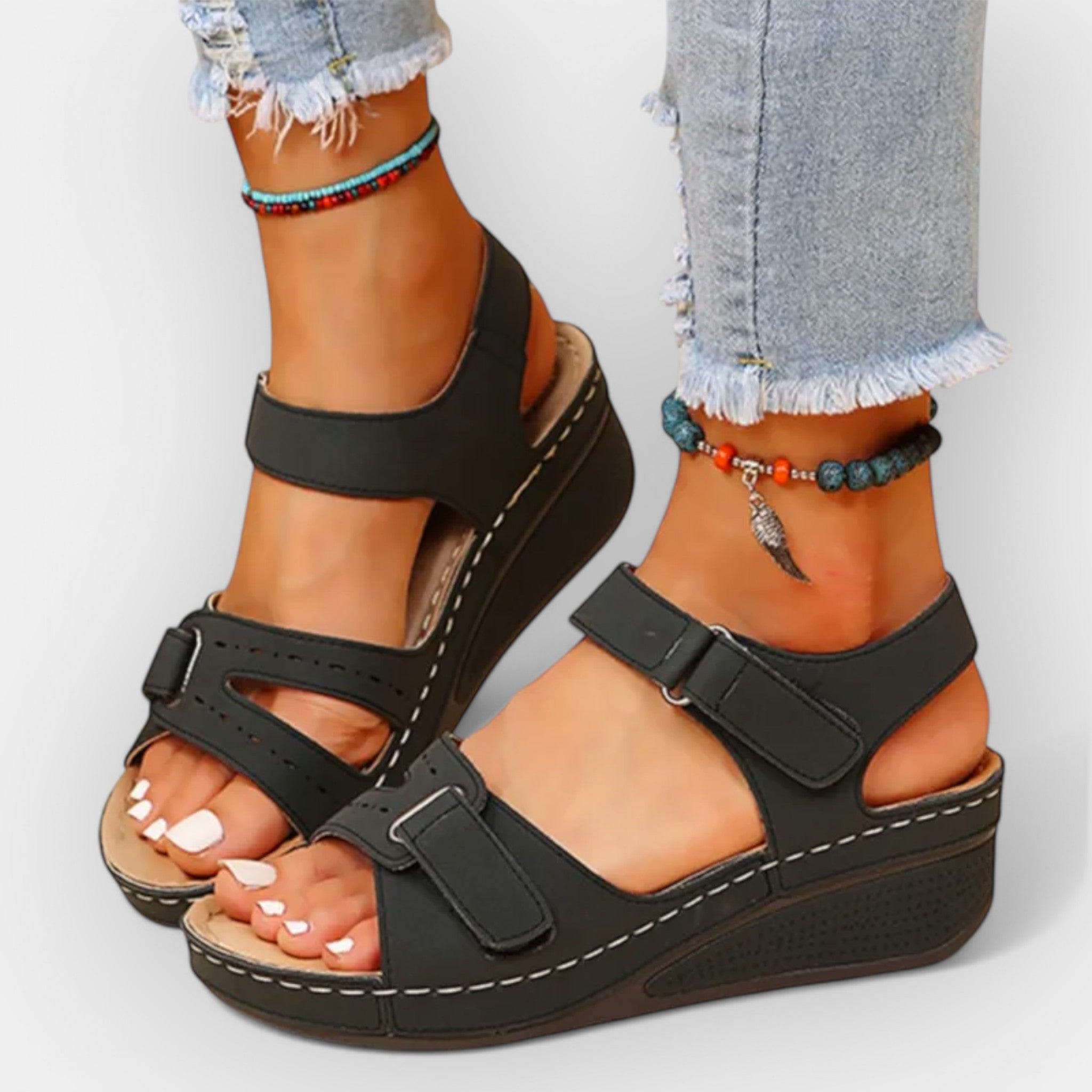 Black open-toe platform sandals with three straps and textured sole edge