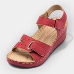 Red open-toe platform sandals with buckle ankle strap and decorative stitching